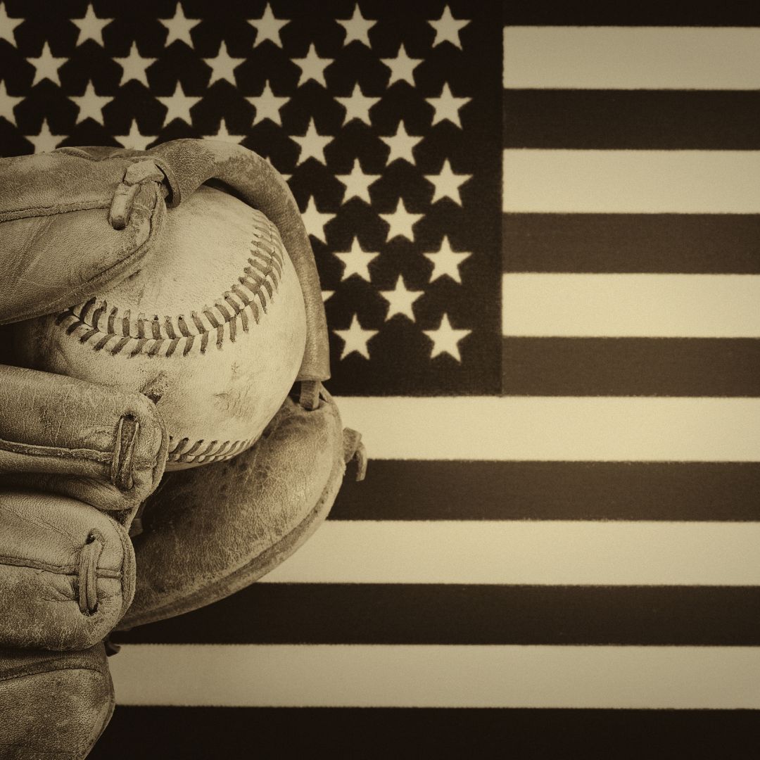 baseball and glove over an American flag